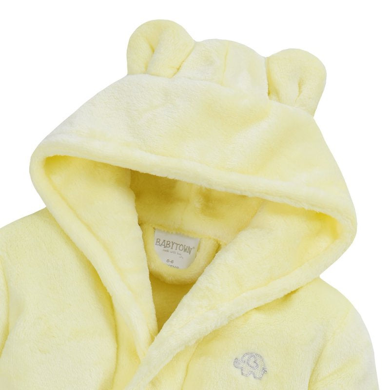 Yellow bear eats hooded fluffy bathrobe