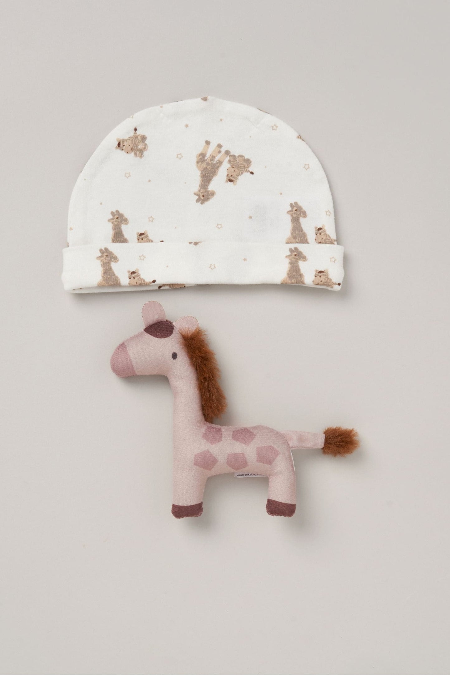 Giraffe print baby cap and giraffe small hand toy. 