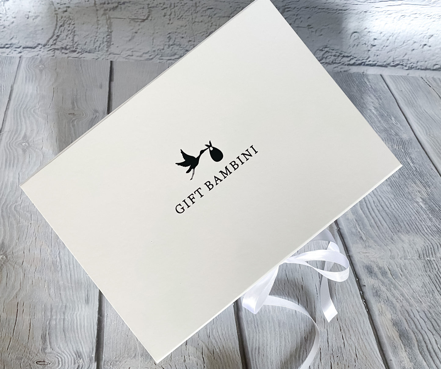 Gift Bambini text and stork logo on gift box