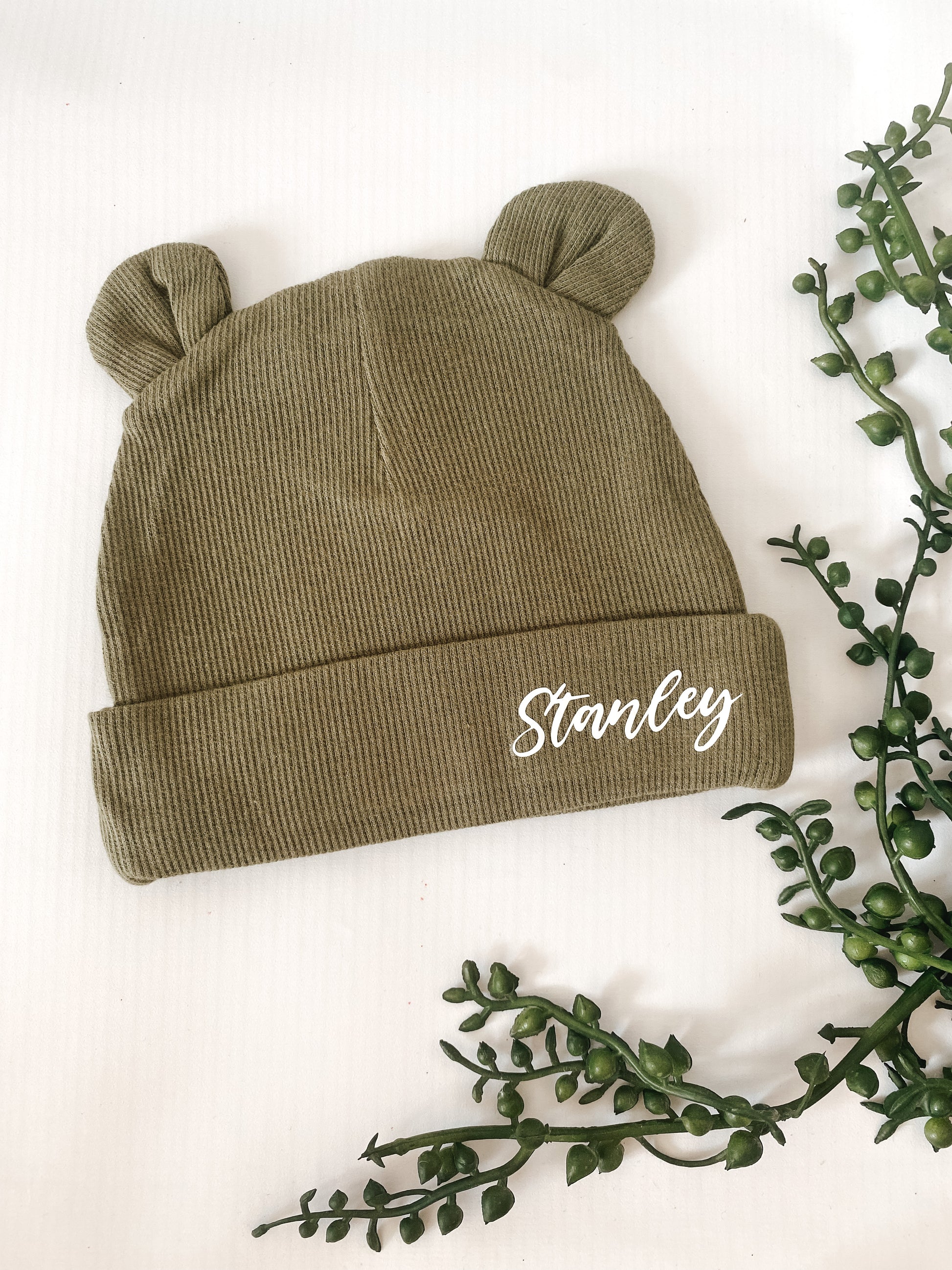 khaki baby bear ears hat ribbed material. Name personalisation in white italic font.