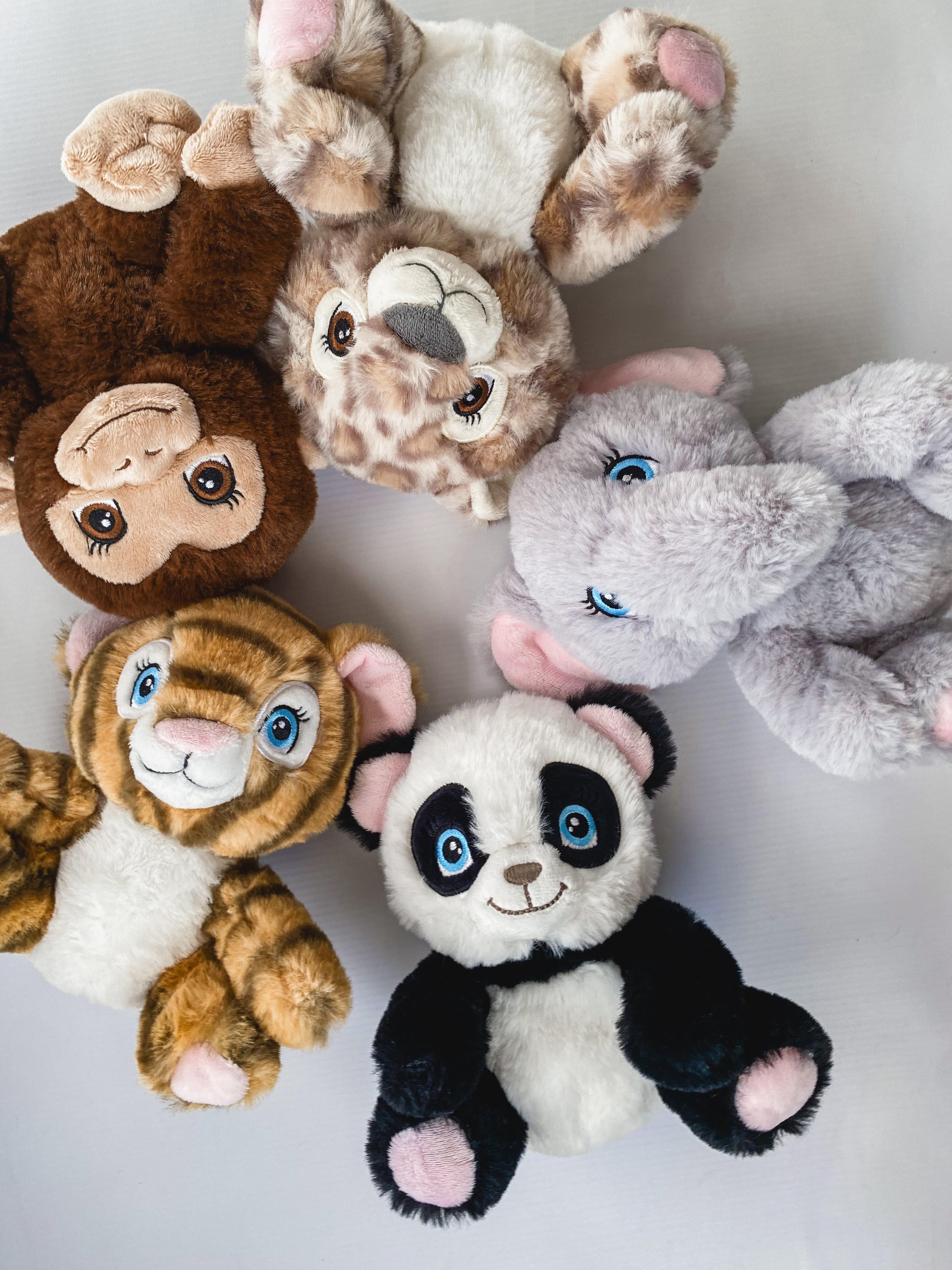 Five animal cuddle toys including panda, elephant, leopard, monkey and tiger.